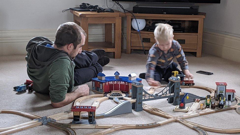 Claire Millington's husband and son play wooden railways during lockdown in the UK