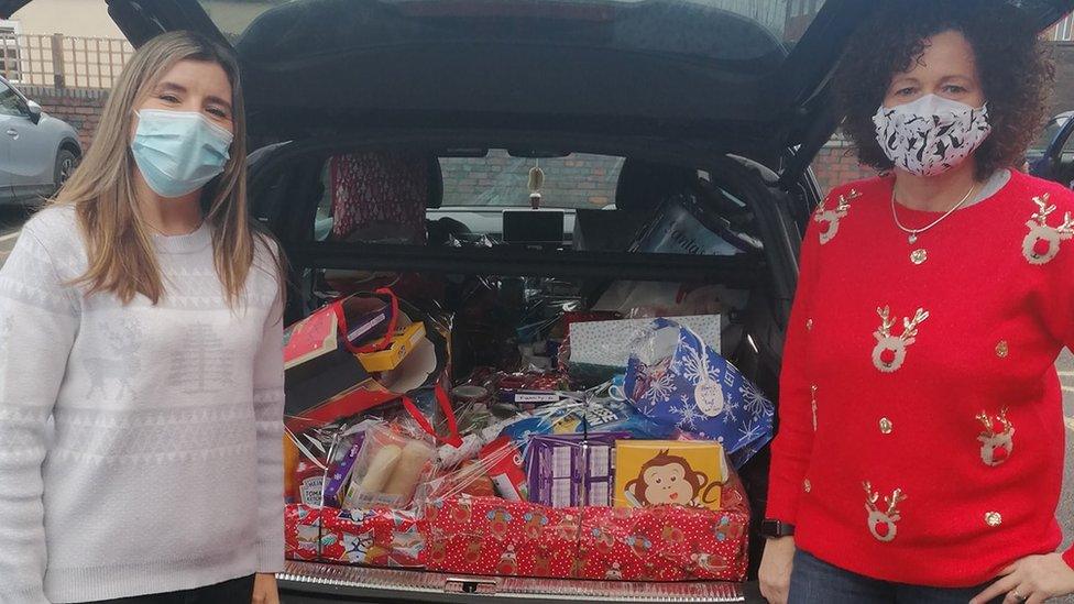 Volunteers with hampers ready to take to a school