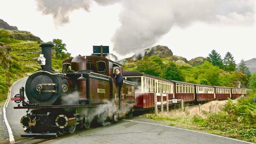 Ffestiniog and Welsh Highland Railways locomotive near Tanygrisiau crossing a road