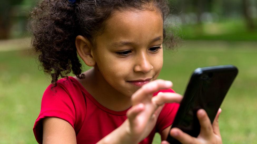 Child holding a mobile phone