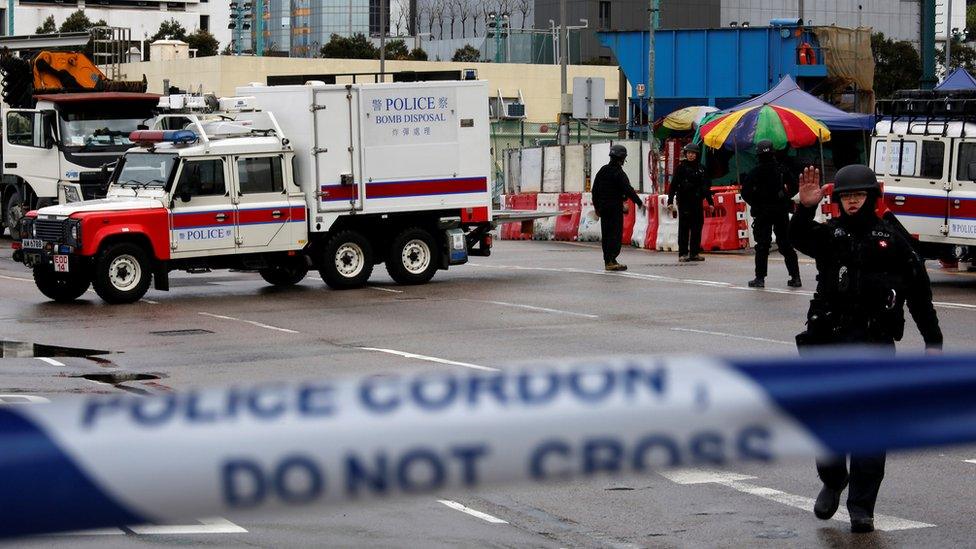 Members of the police bomb squad cordon off an area where a World War Two bomb was found at a construction site in Hong Kong