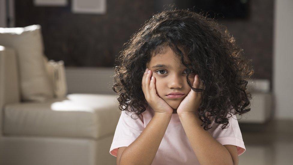 Child-looking-bored-into-camera.