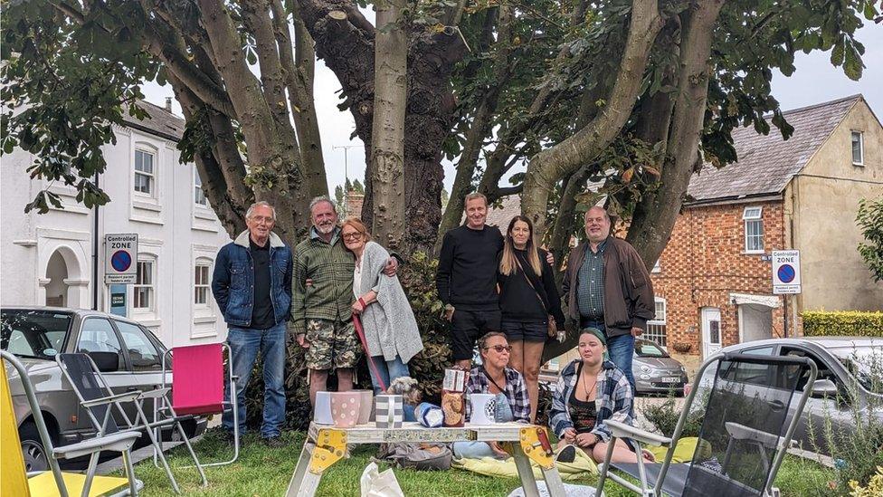 Protestors get comfortable under the tree