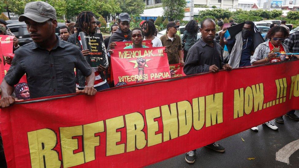 Papuan activists hold banners and shout slogans calling for self-determination, during a demonstration in Jakarta, Indonesia, 19 December 2016.