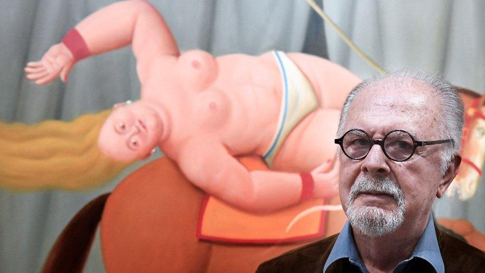 Colombian artist Fernando Botero poses in November 2017 in front of one of his painting displayed in Aix en Provence, southern France.