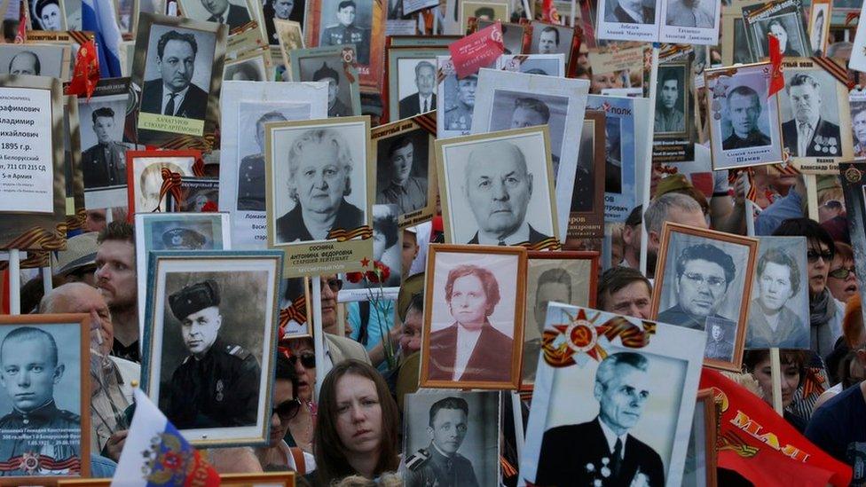 People hold pictures of World War Two soldiers as they take part in the Immortal Regiment march during the Victory Day celebrations, marking the 71st anniversary of the victory over Nazi Germany in World War Two, in central Moscow, Russia, May 9, 2016