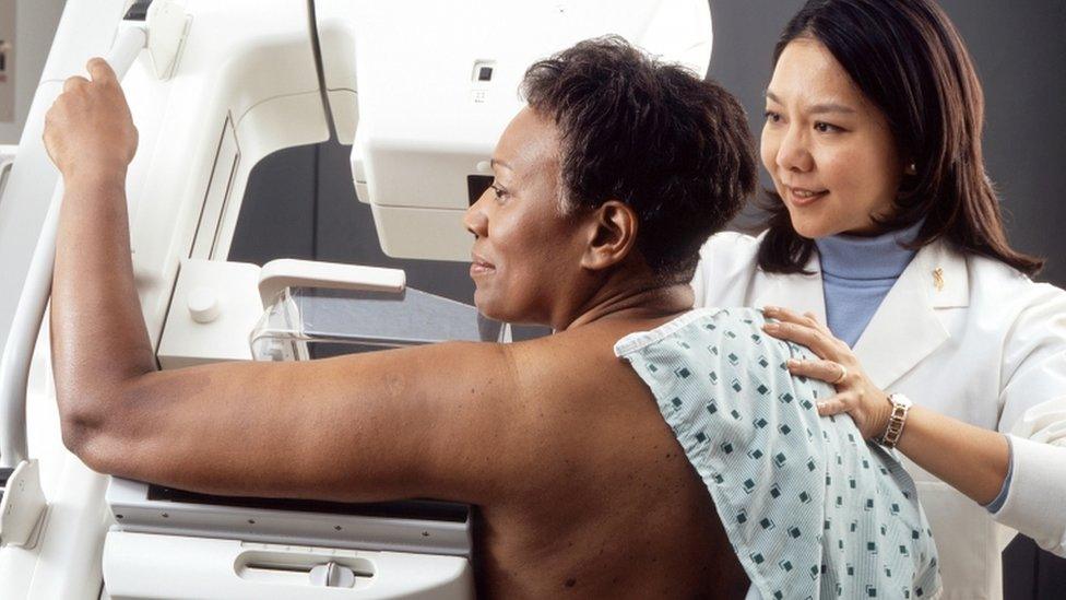 A woman has a screening for breast cancer