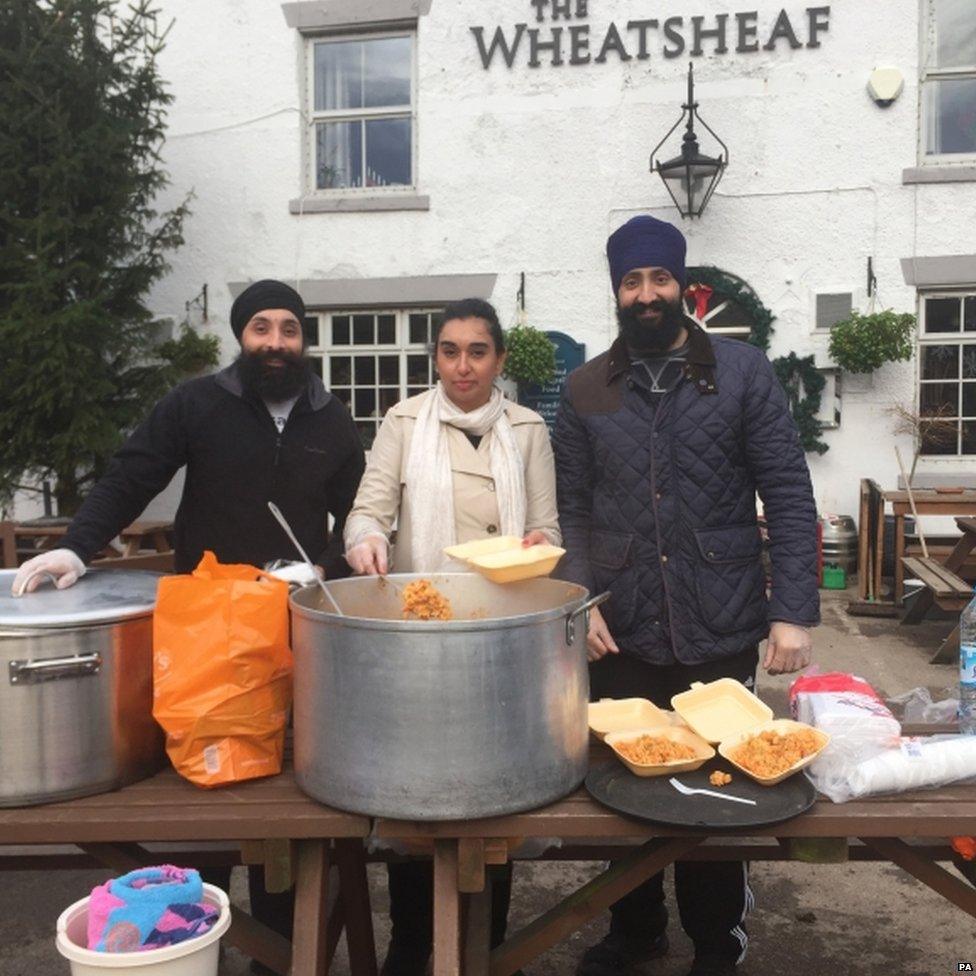 Jarnail Singh, Rani Singh and Gopal Singh, volunteers with Khalsa Aid who have been giving out food to villagers in the flood-hit Lancashire village of Croston