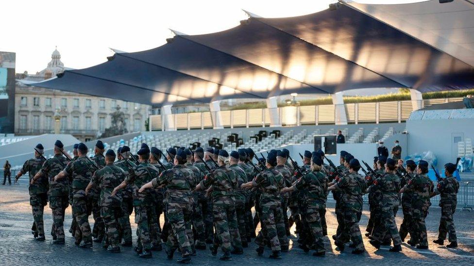 Soldiers march at a military base in Paris