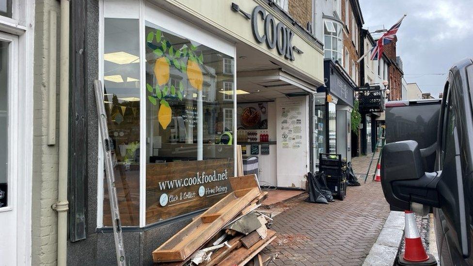 Debris outside the shop in Bishop's Stortford, Hertfordshire, where the truck crashed into