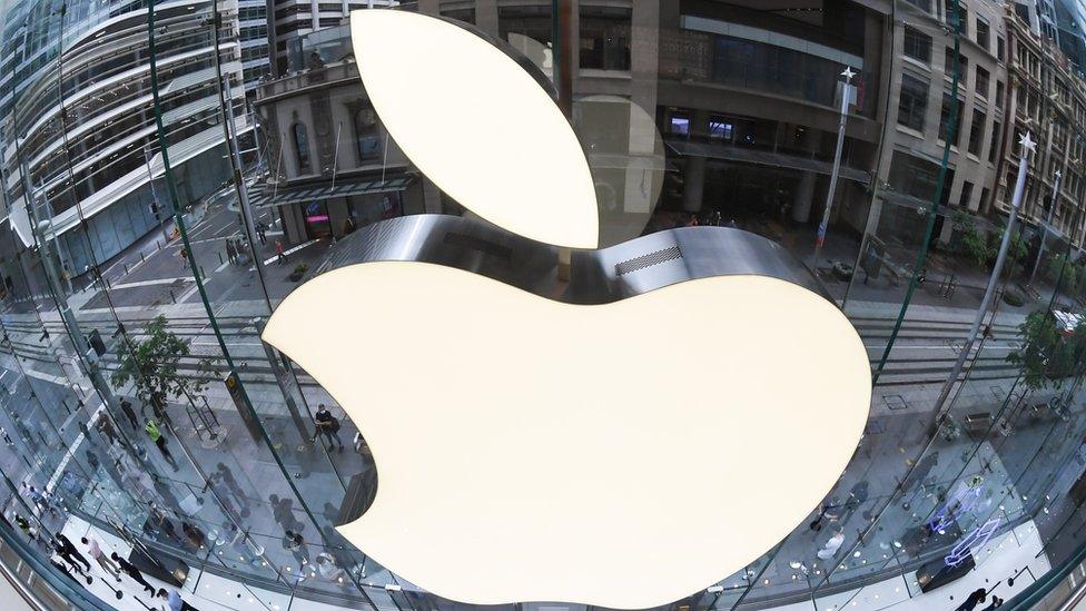 An extreme close-up of the Apple logo on the mirrored surface of the Apple Store on George Street in Sydney, Australia