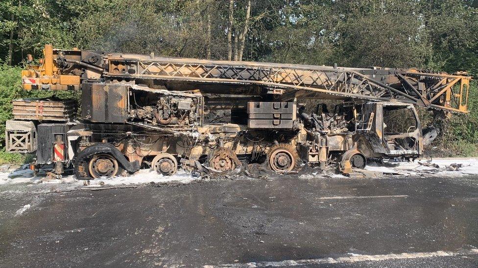 The charred remains of the crane on the A64