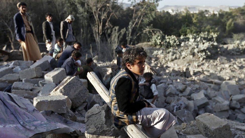 A Yemeni boy sits amid the rubble of damaged houses following a reported Saudi-led coalition air strike on the outskirts of the capital Sanaa on 1 February 2017