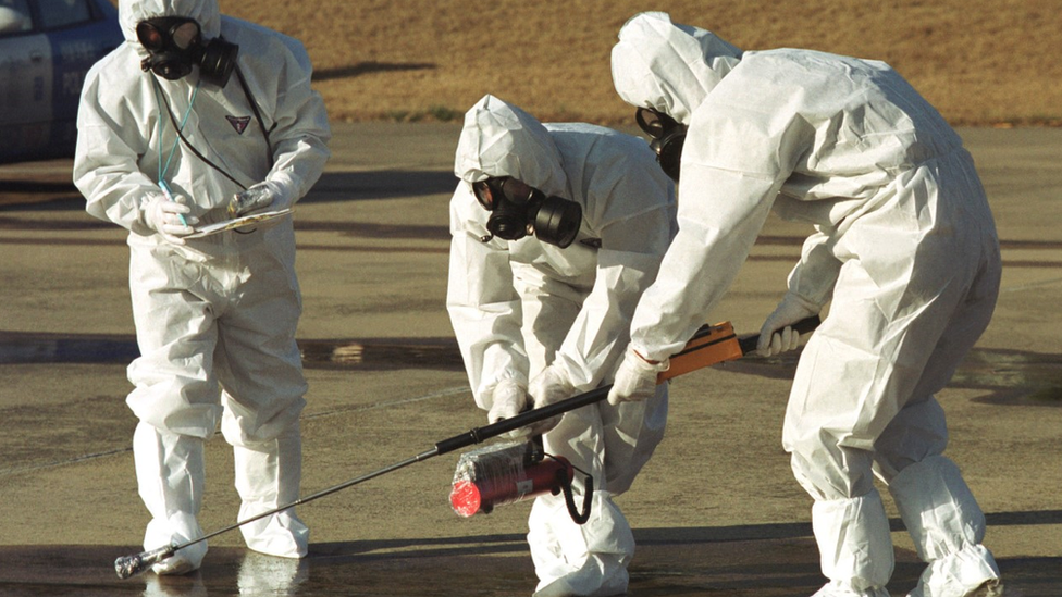 Scientists check for nuclear radiation in a city street