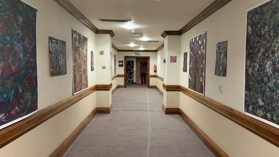 Corridor with artwork on the walls