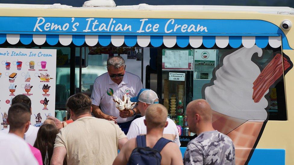 People queuing for ice cream at Loch Lomond, in the village of Luss in Argyll and Bute, Scotland