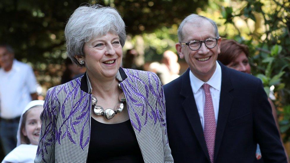 Theresa May and her husband Philip leaving a local church