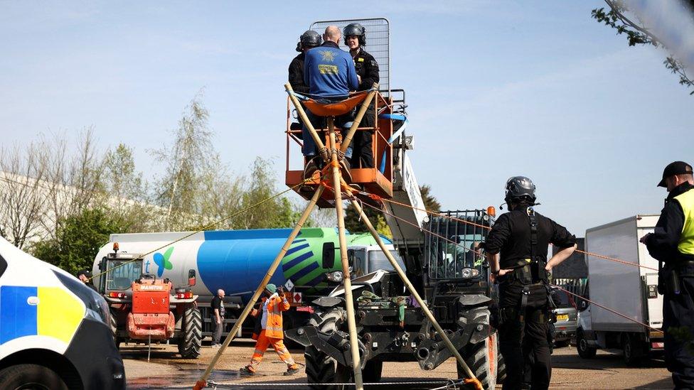 Activists from Just Stop Oil block an entrance to a fuel terminal during a protest in Grays.