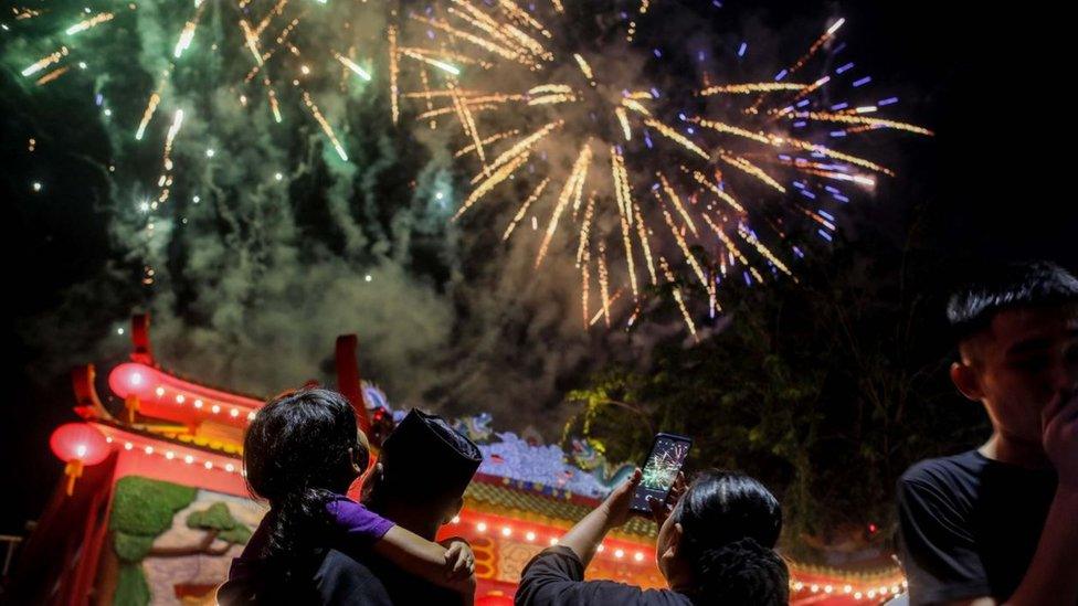 Fireworks light up the sky during the Chinese Lunar New Year Eve celebrations at the Pak Pie Hut Cou temple in Medan, North Sumatra, Indonesia.