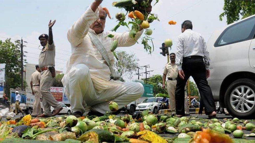 Farmers throwing vegetables on a road during a protest as part of the Maharashtra bandh over various demands in Nagpur, Maharashtra