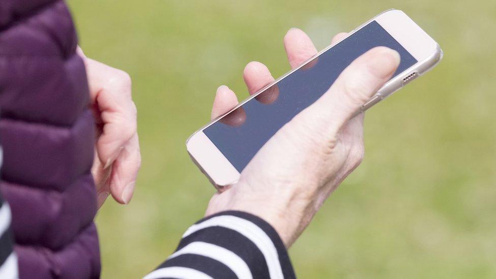 Woman's hand holds phone