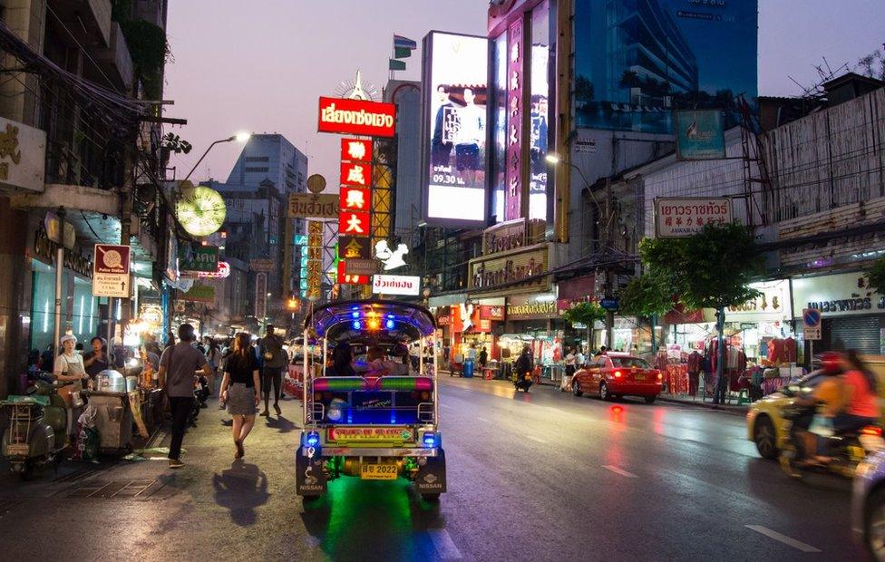 Picture of a Thai street lined with hawkers in Bangkok