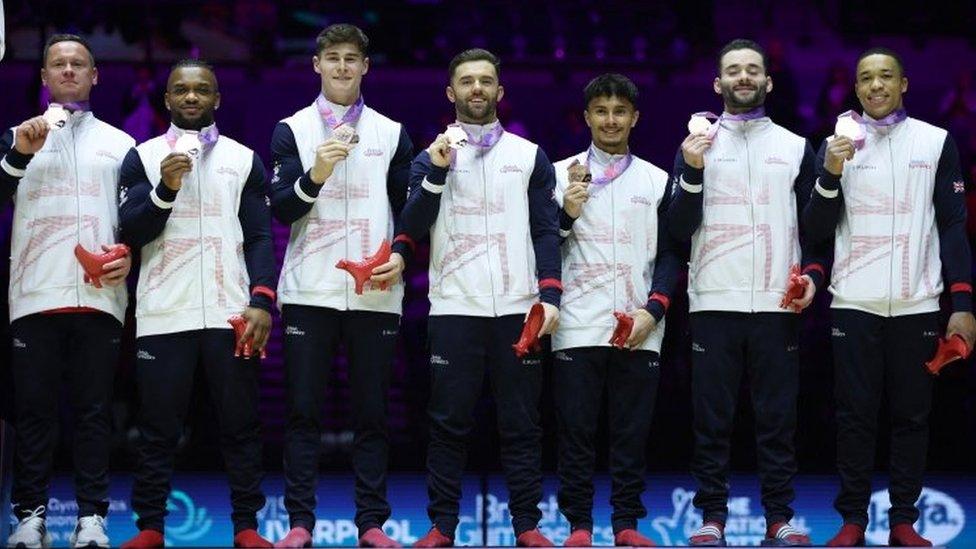 Team GB celebrate on the podium with their medals after winning bronze at the men's team final