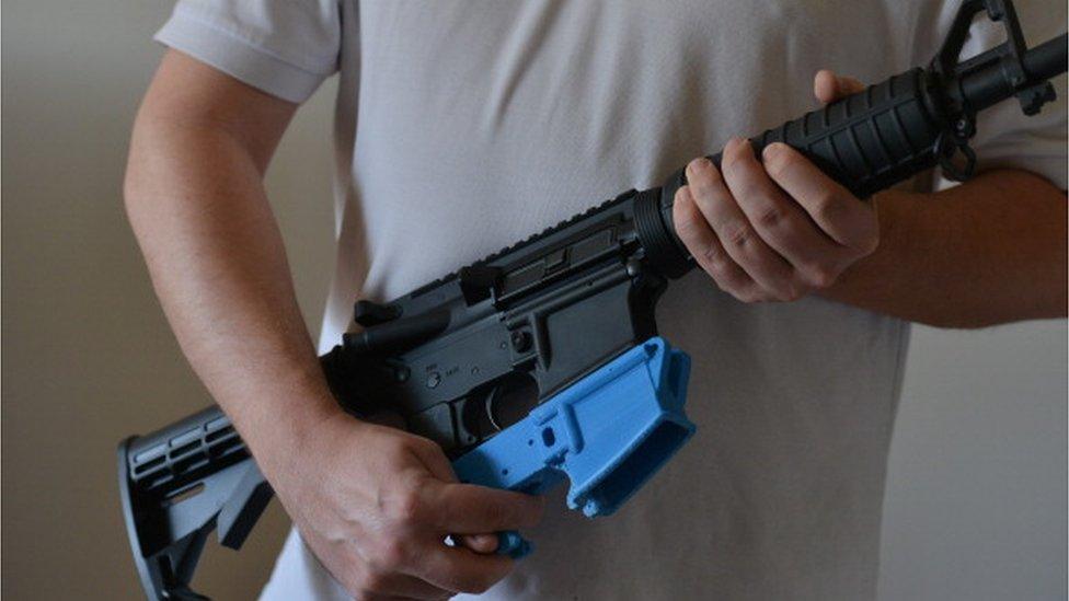 An AR-15 rifle along with a 3D-printed lower receiver