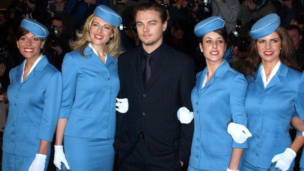 Leonardo DiCaprio Attends The "Catch Me If You Can" Uk Film Premiere in 2003, surrounded by four women dressed as flight attendants