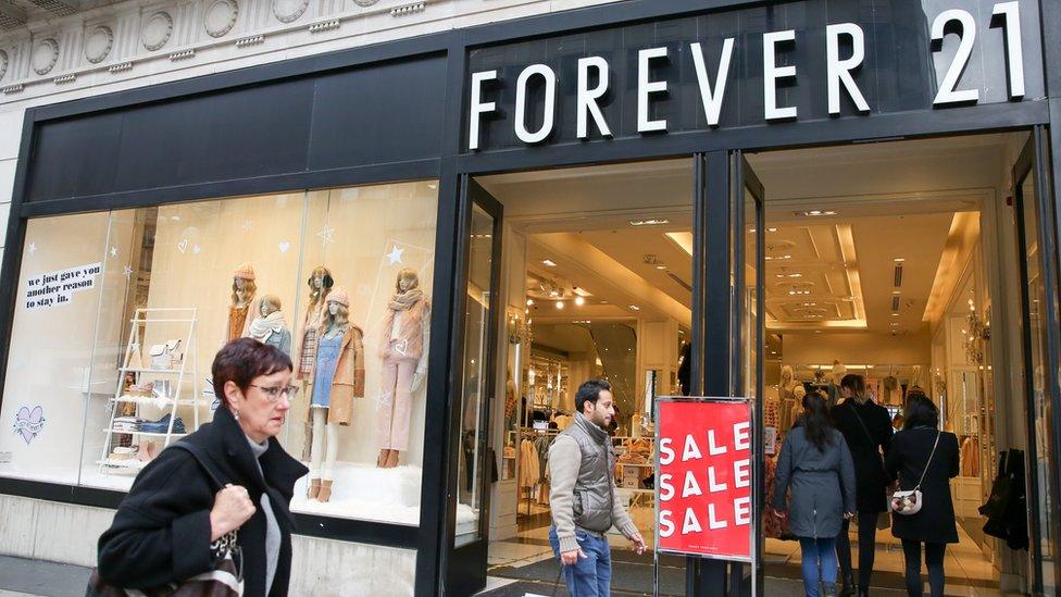 Shoppers are seen outside Forever 21 store on London's Oxford Street.