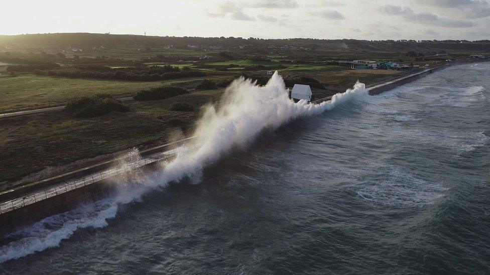 St Ouen's coast with wave crashing onto path