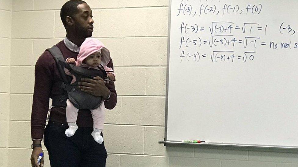 Professor Nathan Alexander hold baby Assata