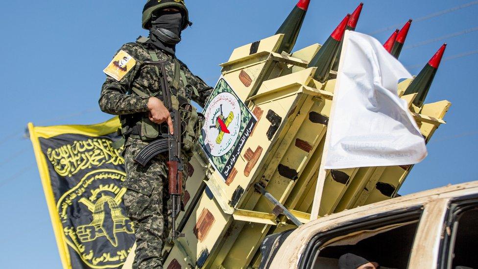 Armed fighters of al-Quds Brigades, the military wing of Islamic Jihad, seen aboard truck-mounted rockets and other weapons during an anti-Israel military parade in Rafah, southern Gaza Strip, 24 August 2022