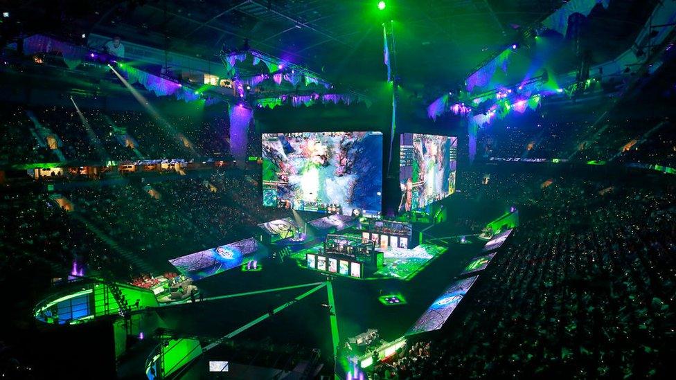 Members of PSG.LGD and OG sit in their booths as they play in their grand final Dota 2 match on Day 6 of The International 2018 at Rogers Arena on August 25, 2018 in Vancouver, Canada.