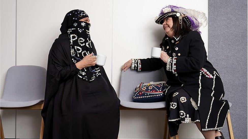 Two women wearing modern versions of the traditional Pearly Queen outfits