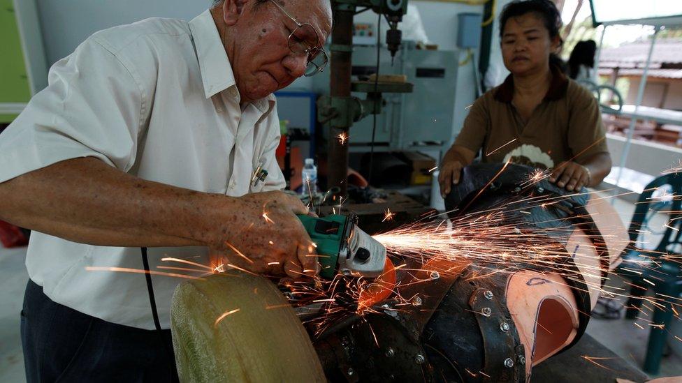 Engineers adjust the prosthetic elephant leg