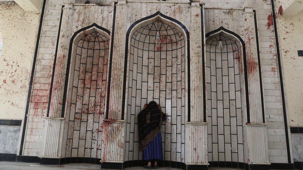 Woman at bloodstained wall