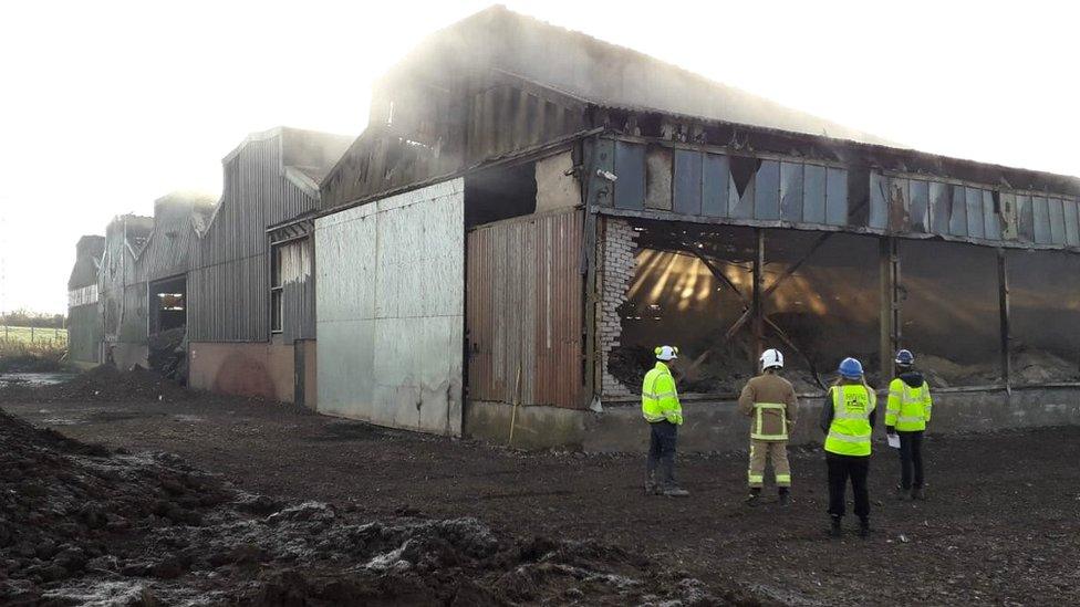 Fire teams outside the burned out building