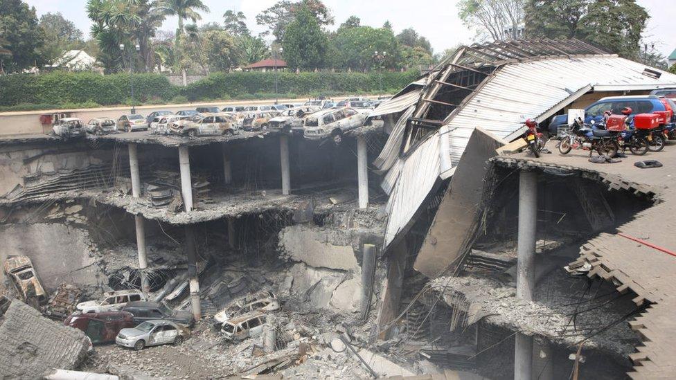 In this handout photo provided by the Kenyan Presidential Press Service, The remains of cars and other debris can be seen in a general view photographed from the rooftop, of the parking lot outside the Westgate Mall on September 26, 2013 in Nairobi, Kenya