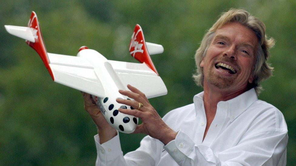 Sir Richard poses with a model of the Virgin spaceship in 2004, after announcing his intention to offer space flights to paying passengers