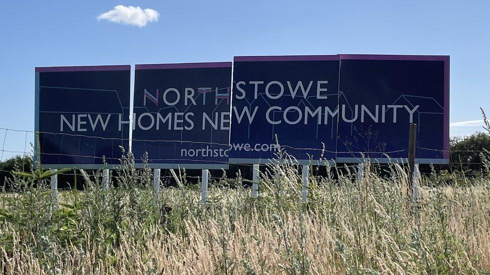 A billboard reading "Northstowe New Homes New Community