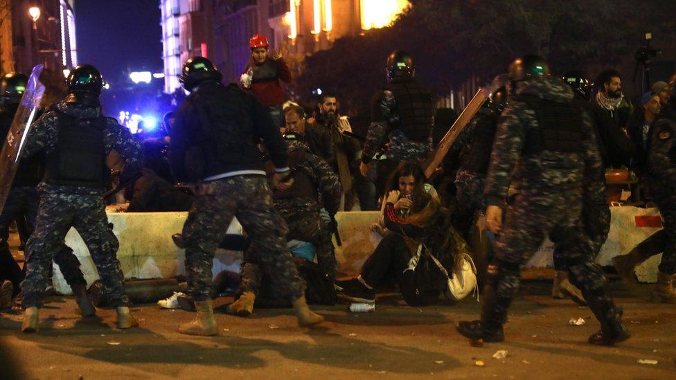 Lebanese security forces remove protesters during an anti-government demonstration