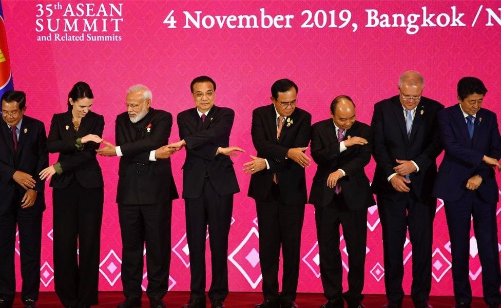 (From L to R) Cambodia's Prime Minister Hun Sen, New Zealand's Prime Minister Jacinda Ardern, India's Prime Minister Narendra Modi, China's Premier Li Keqiang, Thailand's Prime Minister Prayut Chan-O-Cha, Vietnam's Prime Minister Nguyen Xuan Phuc, Australia's Prime Minister Scott Morrison and Japan's Prime Minister Shinzo Abe prepare to pose for a group photo during the 3rd Regional Comprehensive Economic Partnership (RCEP) Summit in Bangkok in November 2019