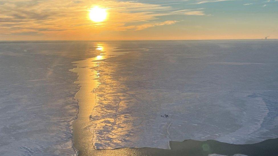 Stranded group on ice sheet