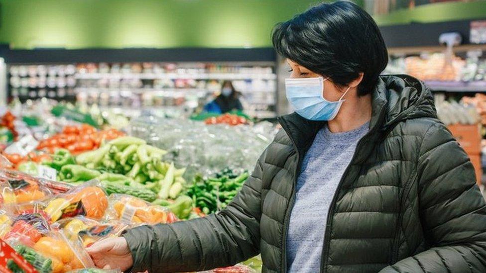 Woman wears a mask in a supermarket