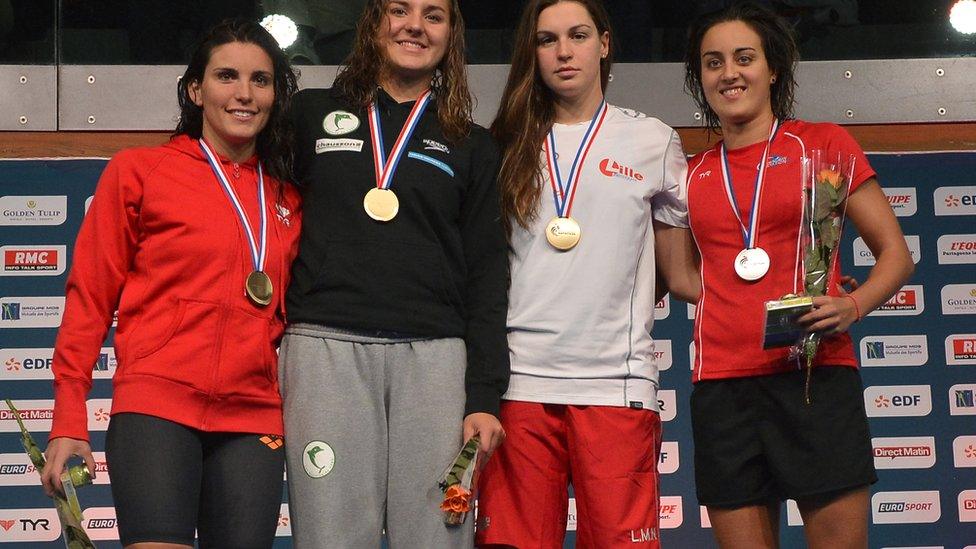 Carmella with other swimmers receiving medals