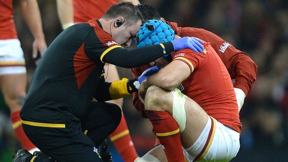 Justin Tipuric receives treatment after being injured playing for Wales against Italy