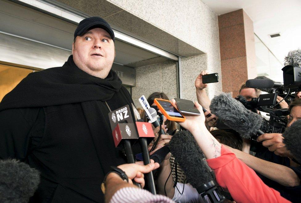 German tech entrepreneur Kim Dotcom speaks to the press after appearing in an Auckland courthouse, 23 December 2015