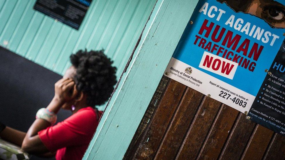 A poster in an office in Georgetown, Guyana which reads, "Act against human trafficking now"