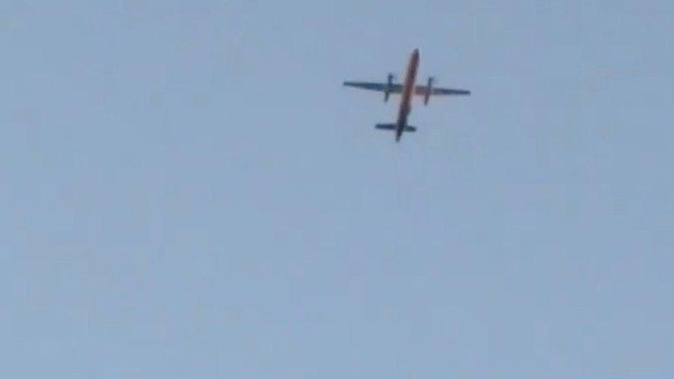 A Horizon Air Bombardier Dash 8 Q400, reported to be hijacked, flies over Fircrest, Washington, the U.S., before crashing in the South Puget Sound,